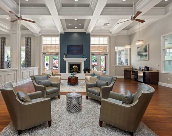 A living room with a fireplace and a large rug.