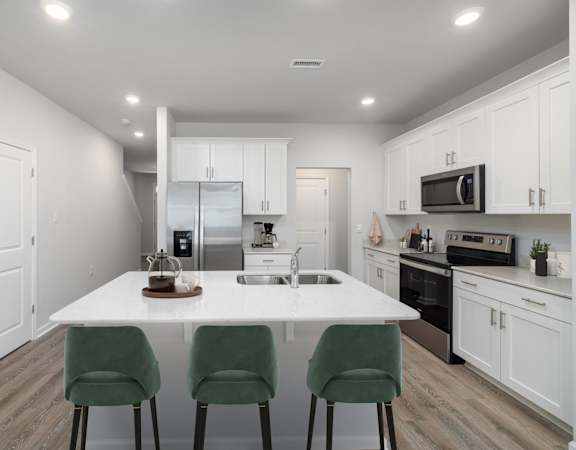 a kitchen with white cabinets and a white counter top