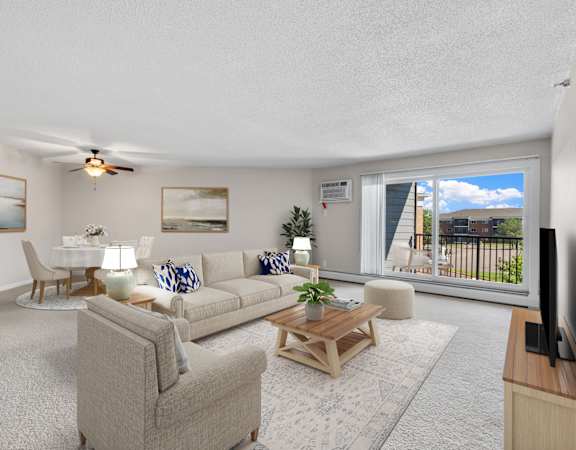 A living room with a couch, chair, and television.