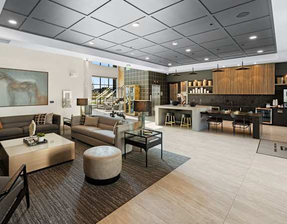 a lobby with couches and chairs and a bar and a living room