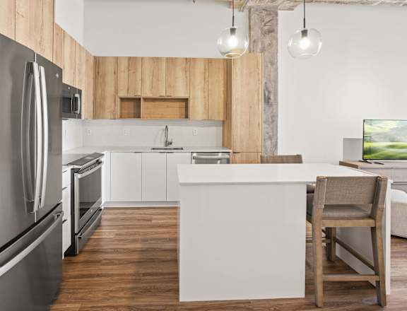 A modern kitchen with a wooden backsplash and stainless steel appliances.