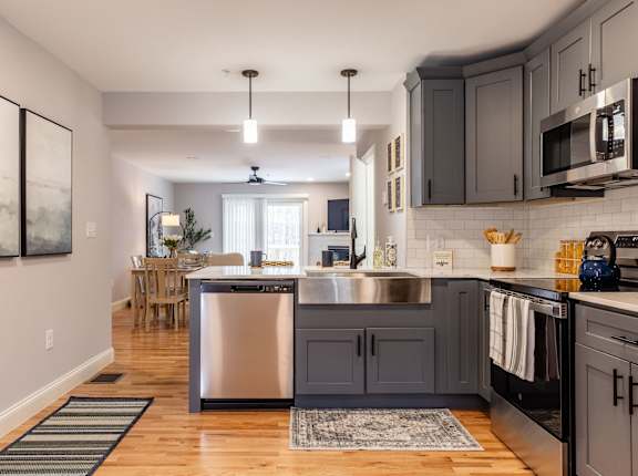 A modern kitchen with a large island and stainless steel appliances.