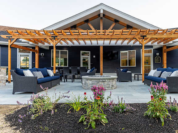 A patio with a pergola and outdoor furniture.