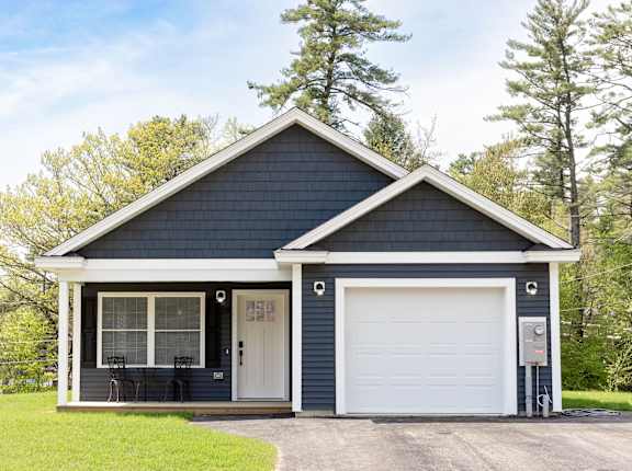 A two-car garage with a white door and a small porch.
