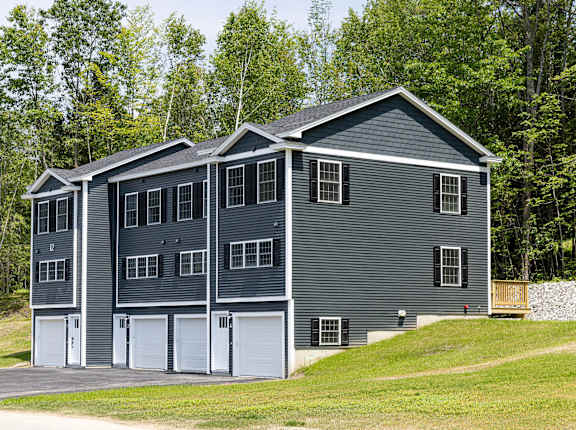 A grey house with a white garage door.