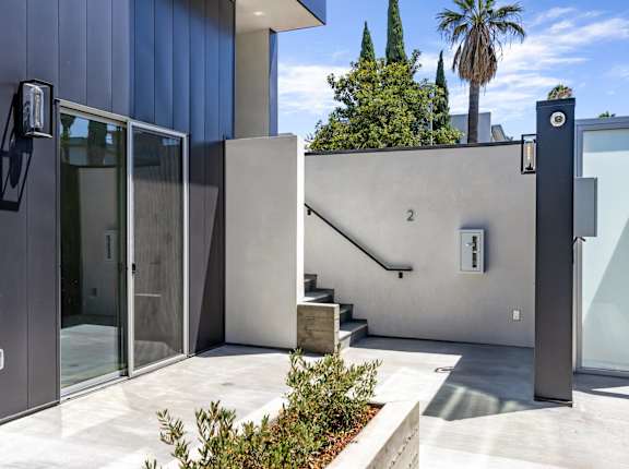 a modern house with a staircase and a glass door