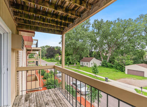 the view from the balcony of a house with a wooden railing and a wooden deck