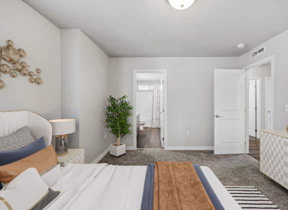 a bedroom with a large bed and a door to a hallway