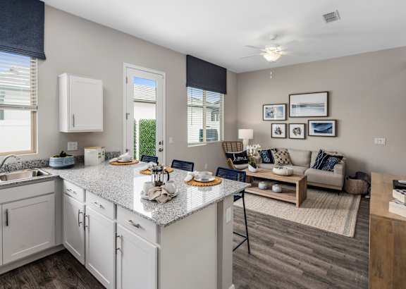 A kitchen with a dining area and a couch.