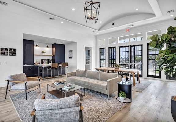 a living room filled with furniture and a large window