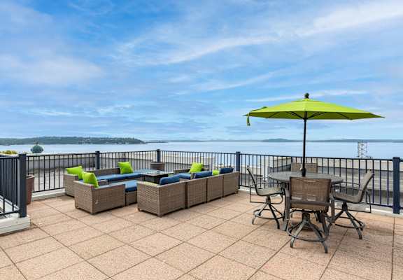 the patio has a table and chairs and an umbrella