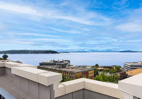 the view of the water from the balcony of a building overlooking the city of tac