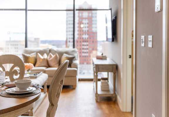 A modern living room with a view of a city skyline.