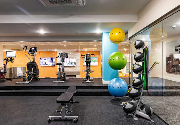 a gym with weights and balls and other exercise equipment