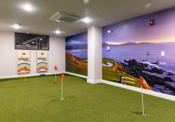 a putting green in a room with a view of the ocean
