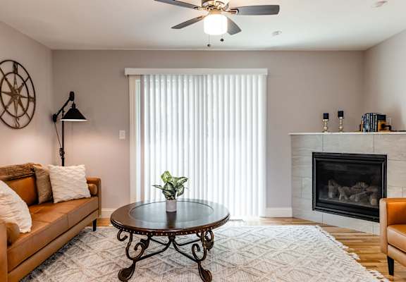A living room with a fireplace and a couch.