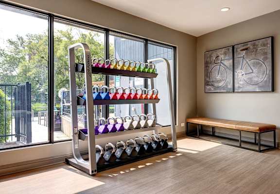 a room with a rack of wine bottles and a bench