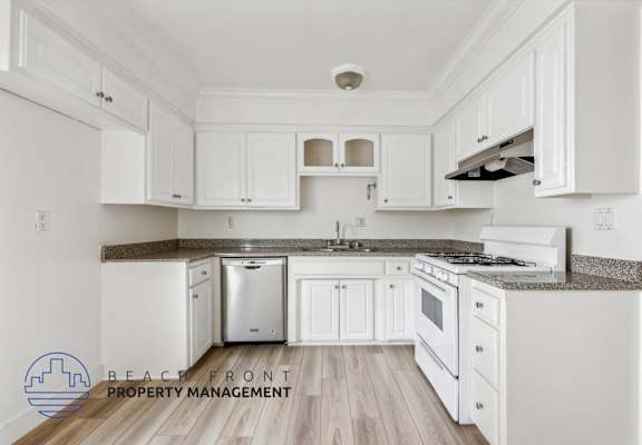 A kitchen with white cabinets and a stainless steel dishwasher.