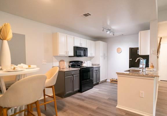 an open kitchen and dining area with a table and chairs