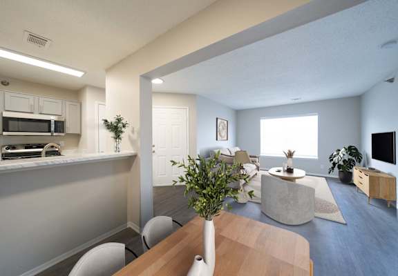 A modern kitchen with a dining table and chairs.
