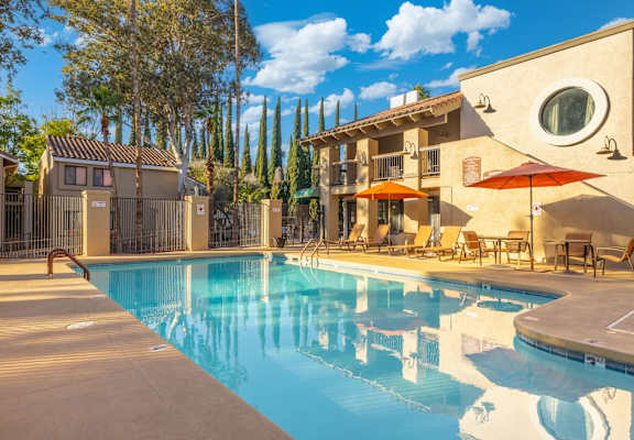 A pool with a building behind it.