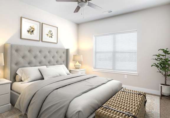 a bedroom with a large bed in front of a window with blinds