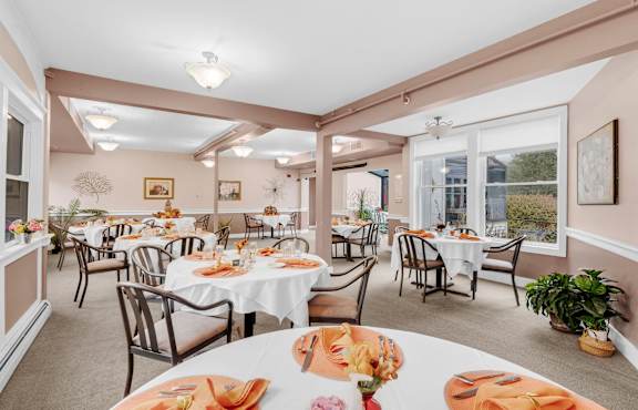 a dining room with tables and chairs and windows