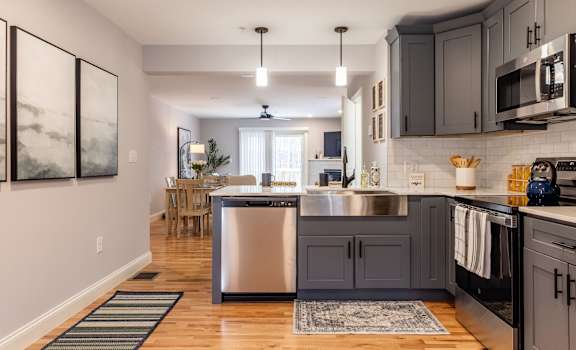 A modern kitchen with a large island and stainless steel appliances.