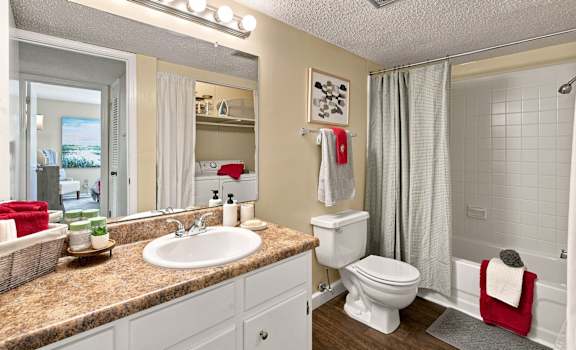 A bathroom with a sink, toilet, and shower.