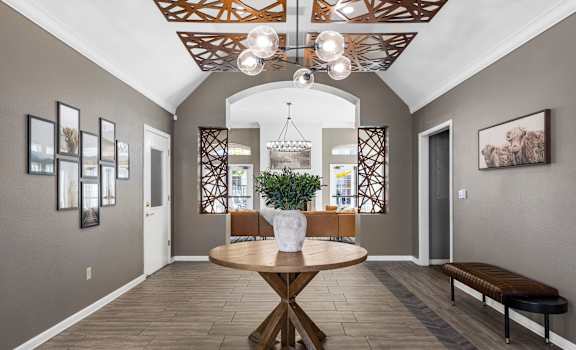 a dining room with a table and a chandelier
