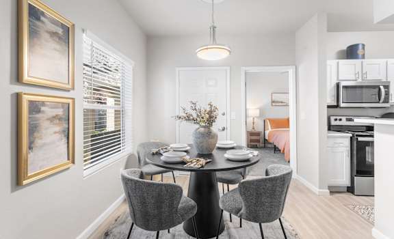 a dining room with a table and chairs