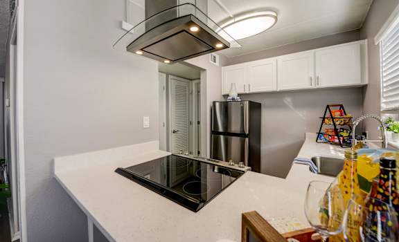 a kitchen with a island and a stove and a refrigerator