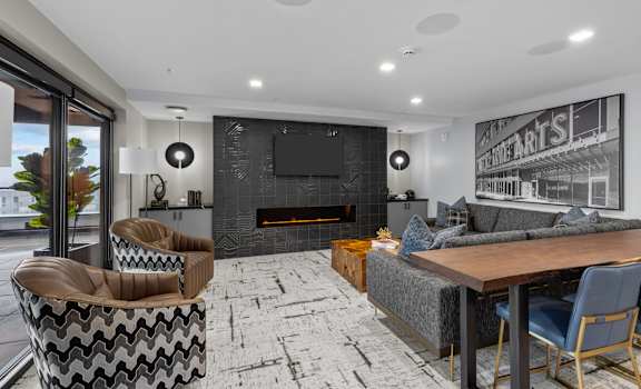 A modern living room with a fireplace and a television.