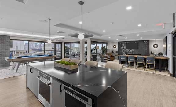 a large kitchen with an island and a pool table