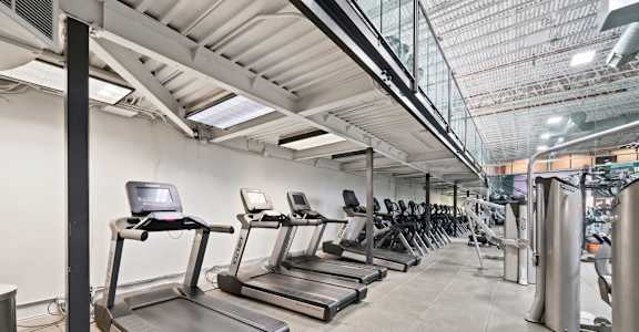 A gym with treadmills and other exercise equipment.