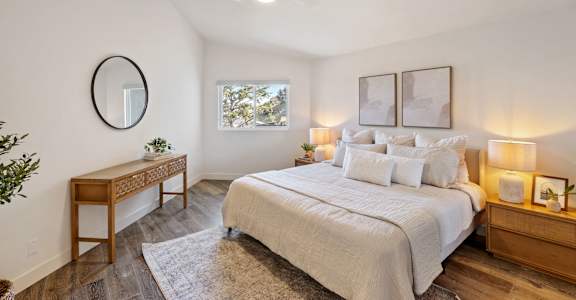 a bedroom with a large bed and a ceiling fan