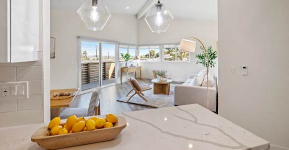 a living room with a table with oranges on it
