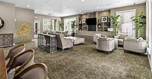 A spacious living room with a patterned carpet and furniture at Fruitland Meadow Apartments, Salem, OR 97317