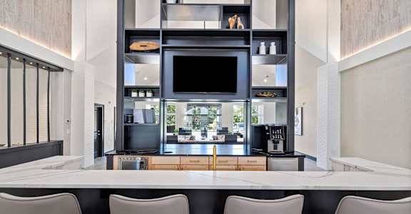 a kitchen with a table and chairs and a television