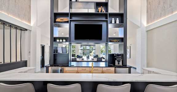 a kitchen with a table and chairs and a television