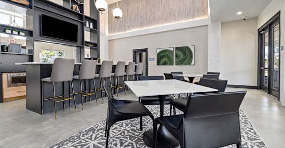 a dining room with a long table and chairs
