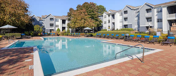 a swimming pool with apartments in the background