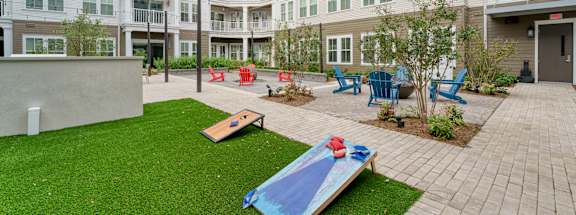 a courtyard with a surfboard in front of an apartment building