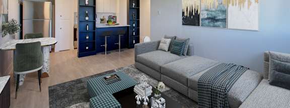 A living room with a grey couch and a green chair.