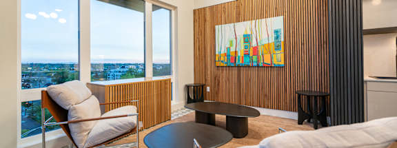 A living room with a large window overlooking the city.