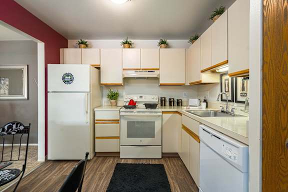 a kitchen with white appliances and white cabinets
