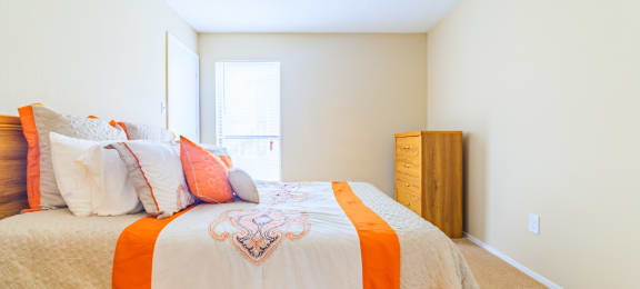 Forest Lake at Oyster Point in Newport News VA interior view of bedroom with orange and white linens