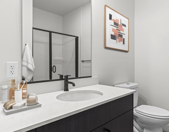 a bathroom with a sink and toilet in a 555 waverly unit