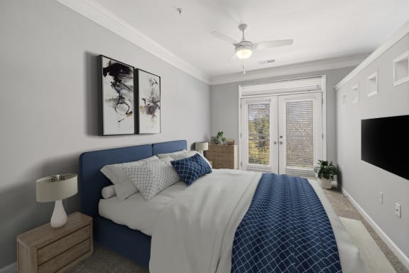 a bedroom with a bed and a ceiling fan