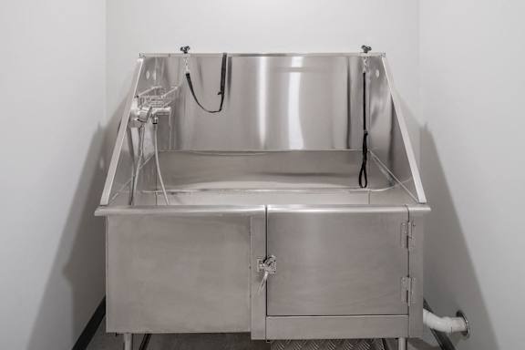 a large stainless steel sink in a white room